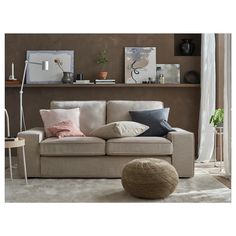 a living room with a beige couch and pillows