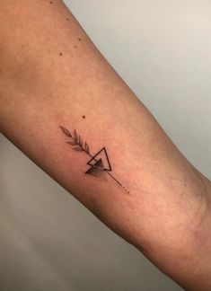 a small triangle tattoo on the arm