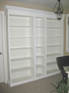 a white bookcase in the corner of a room