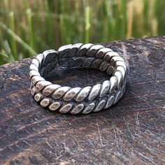 Braided Hilltribe silver band ring   Adjustable ring  , fits sizes 6.5 to 8    Approximately 7mm height Thai Karen Hill Tribe Silver contains 97-99% pure silver - higher than sterling silver's 92.5%. Higher silver content results in natural, lustrous texture and color. High-content silver is softer and easier to shape into beautiful, ornate styles. Using methods that have been passed down for generations, each piece has been individually handcrafted by skilled craftsmen from the native Karen Hill Tribe of Northern Thailand, thus maintaining its uniqueness. No two samples are exactly alike, in contrast to mass-produced jewelry. Adjustable Double Band Sterling Silver Ring, Stackable Adjustable Rings With Thick Band, Silver Adjustable Engraved Snake Ring, Adjustable Thick Band Metal Stackable Rings, Adjustable Silver Nickel-free Snake Ring, Adjustable Nickel-free Silver Snake Ring, Adjustable Silver Rings Stamped 925, Adjustable Sterling Silver Engraved Ring, Nickel Free, Adjustable Nickel-free Sterling Silver Engraved Ring