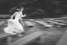 black and white photograph of a man and woman running