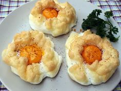 three small pastries on a white plate with parsley