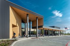 people are standing outside the entrance to a building with columns and pillars on each side