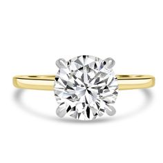 a yellow gold engagement ring with a round brilliant diamond in the center, on a white background