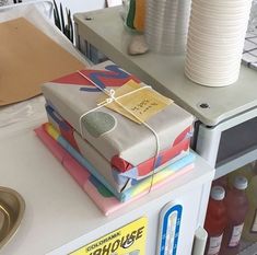 a stack of wrapped presents sitting on top of a counter