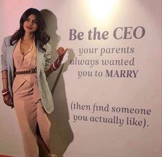 a woman standing in front of a sign that says be the ceo your parents always wanted to you to marry