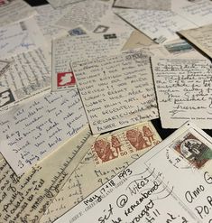 many letters and envelopes are piled on top of each other