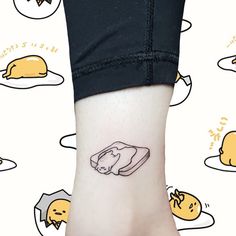 a person with a small tattoo on their ankle that has an image of a toaster and eggs