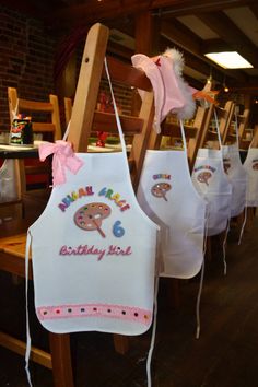 the aprons are decorated with pink bows