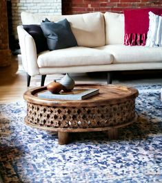 a living room with a couch, coffee table and rug