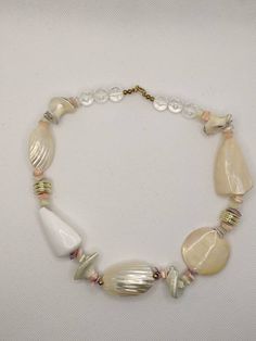 This shell necklace is awesome. All of the shell pieces are polished to show the mother of pearl in the shells. There are 2 gold plated spacers, 4 brass beads, 6 clear plastic beads and a spring clasp. The necklace has small pieces of pink, purple, and cream shells. The necklace sits just below your collarbone. ICM001990P Please check out my other store PIXXIE TREASURES for all your fondant and gum paste flowers needs for cake and cupcake decorating. pixxietreasures.etsy.com Shells Beach, Fairy Pendant, Gum Paste Flowers, Cupcake Decorating, Shell Beach, Brass Beads, Shell Necklace, Pearl Shell, Plastic Beads