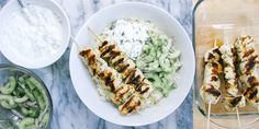 two plates with chicken skewers, pasta salad and dip on a marble table