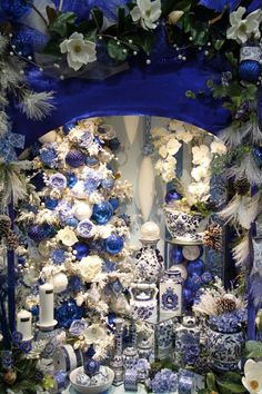 a blue and white christmas display with ornaments