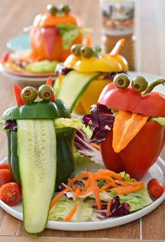 the vegetables are made to look like bugs and have eyes on their faces as they sit on a plate