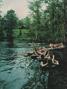 people are floating in the water with sparklers