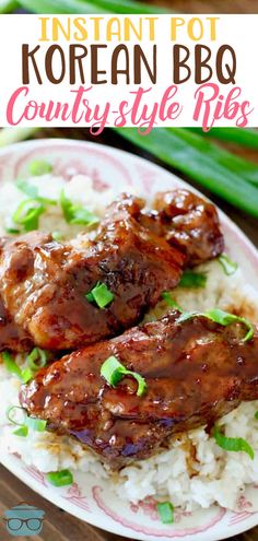 two pieces of meat on top of rice with green onions and scallions in the background