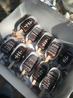 a box filled with chocolate covered cupcakes in the shape of crosses and crosses