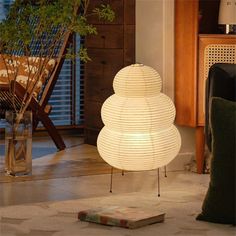 a white lamp sitting on top of a wooden table