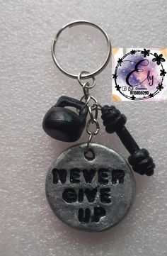 a metal keychain that says never give up