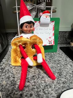 an elf is sitting on top of a hot dog bun