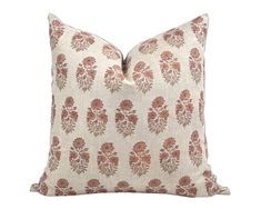 a pillow with an orange and white flower pattern on the front, sitting on a white background