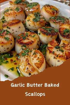 garlic butter baked scallops on a white plate