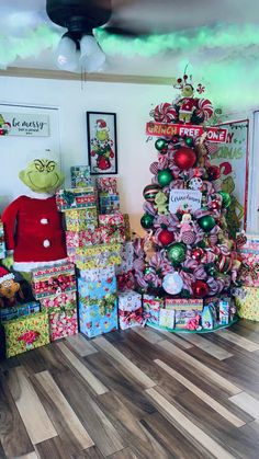 a christmas tree is surrounded by presents on the floor