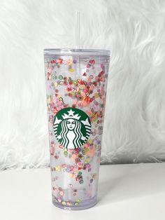 the starbucks cup is filled with confetti and sprinkles