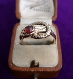 Vintage unisex 9ct yellow gold snake ring, set with a round cut cabochon garnet. The engraved snake is beautifully detailed, with his tail looping around his head. Garnet: 5mm diameter  Hallmark: Maker's mark 'G&PLd', '9 375' for 9ct gold, date letter 'K' for 1965, assay London Size: UK V1/2, EU 64.5, USA 11.25 Weight: 6.2g Condition: The garnet has some surface abrasions commensurate with age and use. The history of garnet dates back to the Bronze Age, more than 5000 years ago. Its name was der Latin Word, Garnet Gem, Vintage Sapphire, Gold Diamond Wedding Band, Garnet Pendant, Fringe Necklace, Pomegranate Seeds, Snake Ring, Red Band