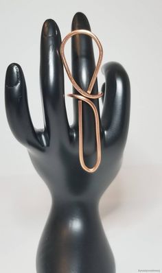 a black hand with a gold ring on it