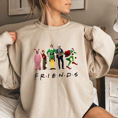 This Friends Christmas Ugly Sweatshirt is a must-have for your winter/Christmas wardrobe. Whether you're attending a Christmas party, staying cozy at home with family and friends, or simply need collecting more sweater-weather crewnecks, this unisex sweatshirt is perfect for you! Our crewnecks are made from the highest quality fabric for an incredibly soft and comfortable fit, with advanced printing and embroidery to ensure that the colors and graphics are vibrant and detailed. ❤ This unisex crewneck sweatshirt is intended to be oversized and loose-fitting for women for a chic and laid-back vibe. If you want something more fitted, we suggest ordering a size down! ❤ How to order your Sweaters: 1. Select the desired Sweater Style/Sweater Color 2. Select the desired Sweater Size 3. Add each s Funny Winter Sweatshirt With Letter Print, Funny Graphic Print Sweatshirt For Winter, Fun Crew Neck Winter Sweatshirt, Fun Winter Crew Neck Sweatshirt, Fun Winter T-shirt With Crew Neck, Funny Long Sleeve Winter Sweatshirt, Funny Cotton Winter Sweatshirt, Funny Cotton Sweatshirt For Winter, Fun Crew Neck Winter Tops