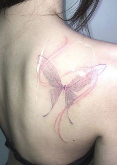 the back of a woman's shoulder with a butterfly tattoo on her left shoulder