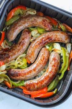 sausages and peppers in a pan on the stove