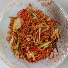 a white bowl filled with noodles and vegetables