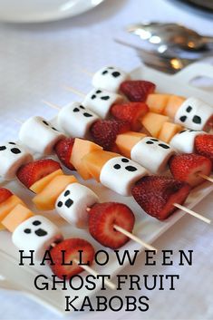 halloween ghost fruit kabobs with marshmallows and strawberries on them