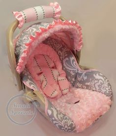 a baby's pink and gray stroller with its hood up, in the shape of a heart