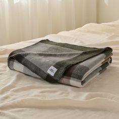 two blankets folded on top of each other on a bed