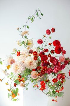 a vase filled with lots of different colored flowers