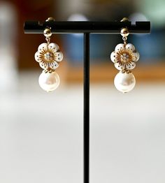 Add a touch of elegance to your wardrobe with these pretty earrings! These elegant fun-style dangle earrings are made with colorful Czech vintagle flower beads and Swarovski pearls. The ear studs are 14k gold plated, ensuring that the earrings are both durable and comfortable to wear. Each pair of these earrings is handcrafted with care and attention to detail, making them a truly unique and special piece of jewelry. They would make a lovely gift for a friend or loved one, or a beautiful additio White Dangle Pearl Clip-on Earrings, White Dangle Clip-on Pearl Earrings, White Pearl Dangle Clip-on Earrings, Elegant Flower Beaded Earrings, Elegant White Flower Shaped Beaded Earrings, Elegant Gold Flower-shaped Beaded Earrings, Elegant Gold Flower Beaded Earrings, Elegant Flower-shaped Beaded Earrings For Party, Elegant Flower Shaped Beaded Earrings For Gift