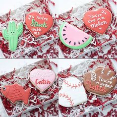 four decorated cookies in a box with some writing on them