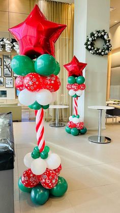 christmas decorations are displayed in the lobby of an office building, decorated with red and green balloons