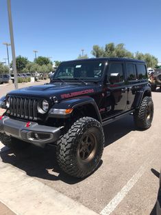 a black jeep parked in a parking lot