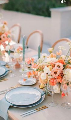 the table is set with flowers and candles on it for an elegant dinner party or wedding reception