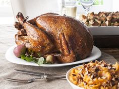 a turkey sitting on top of a table next to other foods