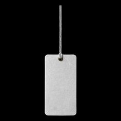 a white tag hanging from a string on a black background