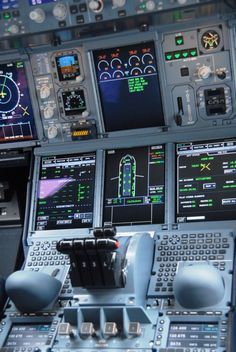 an airplane cockpit with multiple controls and dashboards