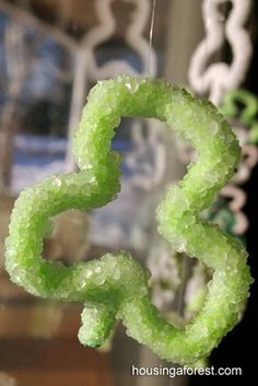 a close up view of some kind of green thing in the air with water droplets on it