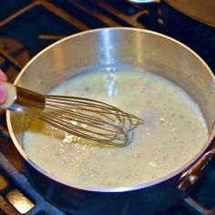 a person is stirring something in a pot on the stove