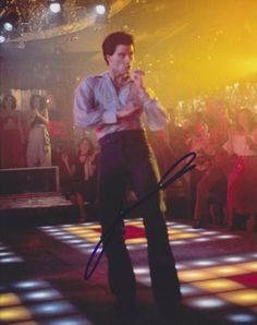 a man standing on top of a dance floor in front of a group of people