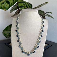 "Romantic and sparkling bridal necklace and earrings. This blue pearl and crystal necklace is beautiful for your wedding day and even for an evening event. Adorn yourself with an elegant blue statement necklace. The blue wedding necklace is beaded with blue Swarovski crystal beads, Czech white pearls, and Japanese seed beads.  ✧ 𝗠𝗘𝗔𝗦𝗨𝗥𝗘𝗠𝗘𝗡𝗧𝗦 ✧ Necklace length: 18.11\" (46cm)  ✧ 𝗨𝗽𝗴𝗿𝗮𝗱𝗲 𝘆𝗼𝘂𝗿 𝗷𝗲𝘄𝗲𝗹𝗿𝘆 𝗰𝗼𝗹𝗹𝗲𝗰𝘁𝗶𝗼𝗻 𝘄𝗶𝘁𝗵 𝘁𝗵𝗲𝘀𝗲 𝗯𝗲𝗮𝘂𝘁𝗶𝗳𝘂𝗹 𝗻𝗲𝗰𝗸𝗹𝗮𝗰𝗲 ✧ ✧ 𝗧𝗵𝗼𝘂𝗴𝗵𝘁𝗳𝘂𝗹𝗹𝘆 𝗽𝗮𝗰𝗸𝗮𝗴𝗲𝗱 𝗶𝗻 𝗮 𝗴𝗶𝗳𝘁 𝗯𝗼𝘅 ✧. For more wedding necklaces click here: https://www.etsy.com/shop/liorajewelry?section_id=18233732&ref=shopsection_leftnav_4 Back to my shop: https://www.etsy.com/shop/liorajewelry Thank you for visiting my shop!" Elegant Blue Pearl Beaded Necklaces, Elegant Blue Beaded Necklace With Pearl Drop, Elegant Blue Beaded Pearl Necklace, Blue Beaded Bridal Necklace For Party, Blue Pearl Drop Necklaces For Wedding, Blue Pearl Drop Necklace For Wedding, Handmade Elegant Blue Bridal Necklace, Elegant Handmade Blue Bridal Necklace, Blue Beaded Pearl Necklace For Wedding